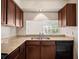 Bright kitchen with stainless steel sink and a pass-through window at 507 Northlake Dr # 507, Sanford, FL 32773