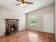 Bright living room featuring a stone fireplace, wood floors, and ample natural light from a window at 507 Northlake Dr # 507, Sanford, FL 32773