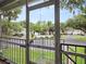 View from screened-in balcony overlooking parking area and landscaped grounds within the community at 507 Northlake Dr # 507, Sanford, FL 32773