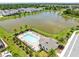 An aerial perspective showing the community pool, clubhouse, and a scenic lake view, enhancing the lifestyle at 5677 Cedar Chase Dr, St Cloud, FL 34771
