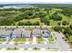 An aerial view of a well-designed home in a desirable neighborhood surrounded by lush greenery and a tranquil lake at 5677 Cedar Chase Dr, St Cloud, FL 34771