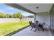 Backyard patio area with table and chairs and grassy lawn at 5677 Cedar Chase Dr, St Cloud, FL 34771