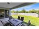 Covered patio with backyard featuring well-maintained lawn and white fence at 5677 Cedar Chase Dr, St Cloud, FL 34771