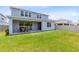 Spacious backyard featuring manicured lawn and covered patio area at 5677 Cedar Chase Dr, St Cloud, FL 34771