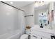 All white bathroom featuring a shower-tub combo, white vanity and matte black fixtures at 5677 Cedar Chase Dr, St Cloud, FL 34771