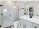 Modern bathroom featuring a glass-enclosed shower, white vanity, and sleek black fixtures at 5677 Cedar Chase Dr, St Cloud, FL 34771