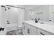 Updated white bathroom featuring black fixtures, vanity and shower-tub combo at 5677 Cedar Chase Dr, St Cloud, FL 34771