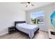 A minimalist bedroom with a comfortable bed, a wooden floor, and a scenic outdoor view at 5677 Cedar Chase Dr, St Cloud, FL 34771