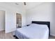 A minimalist bedroom featuring a comfortable bed with an ensuite bathroom at 5677 Cedar Chase Dr, St Cloud, FL 34771