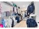 Walk-in closet with ample shelving, hanging space, and wood flooring for organized storage at 5677 Cedar Chase Dr, St Cloud, FL 34771