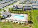 Aerial view of the community pool with lounge chairs and palm trees, offering a relaxing outdoor space at 5677 Cedar Chase Dr, St Cloud, FL 34771