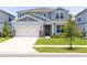 Charming two-story home with a well-manicured lawn and a two-car garage in a Gathering-friendly neighborhood at 5677 Cedar Chase Dr, St Cloud, FL 34771