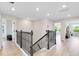 Second floor hallway with wood floors, neutral colors, and views of the downstairs and backyard at 5677 Cedar Chase Dr, St Cloud, FL 34771