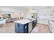 Open concept floorplan with kitchen island featuring barstool seating, stainless appliances, and access to living areas at 5677 Cedar Chase Dr, St Cloud, FL 34771