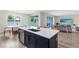 Island sink with backyard view of outdoor living area, seamlessly connecting to the open-concept living and dining area at 5677 Cedar Chase Dr, St Cloud, FL 34771