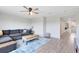 Comfortable living room featuring a ceiling fan, modern décor, and a plush gray sofa at 5677 Cedar Chase Dr, St Cloud, FL 34771
