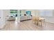 Open-concept living and dining area with stylish furniture, hardwood flooring, and plenty of natural light at 5677 Cedar Chase Dr, St Cloud, FL 34771