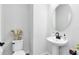 Bright and stylish half bathroom featuring a toilet, a modern sink, and decorative touches at 5677 Cedar Chase Dr, St Cloud, FL 34771