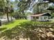 Lush backyard with expansive green space, mature trees, and a well-maintained lawn at 578 3Rd St, Daytona Beach, FL 32117