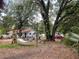 Backyard with mature trees, a hammock, and ample space for outdoor relaxation and recreation at 578 3Rd St, Daytona Beach, FL 32117
