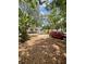 Exterior view showcases backyard with mature trees, landscaping, and ample space for outdoor enjoyment at 578 3Rd St, Daytona Beach, FL 32117