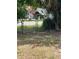 Partially fenced backyard with a glimpse of a building beyond at 578 3Rd St, Daytona Beach, FL 32117