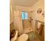 Bathroom featuring a shower with grab bars, and neutral-toned fixtures at 578 3Rd St, Daytona Beach, FL 32117