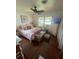 Well-lit bedroom with hardwood floors, complemented by a ceiling fan and ample natural light at 578 3Rd St, Daytona Beach, FL 32117