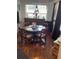 Dining room with wood floors, large windows, and a round table at 578 3Rd St, Daytona Beach, FL 32117