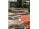 Long private driveway leading to the home, bordered by garden beds and lush landscaping at 578 3Rd St, Daytona Beach, FL 32117