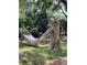 Hammock for relaxing in the backyard, complete with wooden carvings adding a touch of whimsy at 578 3Rd St, Daytona Beach, FL 32117