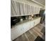 Kitchen featuring white cabinets, granite counters, stainless steel appliances, and wood look floors at 578 3Rd St, Daytona Beach, FL 32117