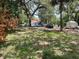 View of property with the house, car, storage shed and mature trees at 578 3Rd St, Daytona Beach, FL 32117