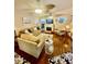 Open-concept living room featuring hardwood floors, ceiling fans, and neutral decor at 578 3Rd St, Daytona Beach, FL 32117