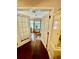 Open view of a brightly lit office space featuring wood floors and french doors at 578 3Rd St, Daytona Beach, FL 32117