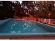 The backyard features a serene, in-ground pool, reflecting the surrounding lush trees, for relaxation at 578 3Rd St, Daytona Beach, FL 32117