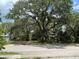 Street view of property with mature oak trees at 578 3Rd St, Daytona Beach, FL 32117