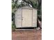 Exterior view of the storage shed and some backyard debris with mature trees and landscaping at 578 3Rd St, Daytona Beach, FL 32117