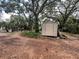 Outdoor storage shed offers practical space for tools, equipment and more, surrounded by mature trees at 578 3Rd St, Daytona Beach, FL 32117