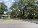 View of property from the street with mature oak trees and house at 578 3Rd St, Daytona Beach, FL 32117