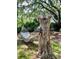 Backyard featuring unique yard art, including a carved tree trunk and hammock, set in a tropical landscape at 578 3Rd St, Daytona Beach, FL 32117