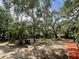 Spacious and private backyard with mature trees and lush greenery, perfect for relaxation and outdoor activities at 578 3Rd St, Daytona Beach, FL 32117