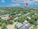 Aerial neighborhood view of home with lush green trees and nearby hospital at 624 Richmond Street, Orlando, FL 32806