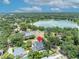 Aerial neighborhood view featuring lush green trees and nearby lake at 624 Richmond Street, Orlando, FL 32806