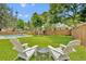 Relaxing backyard with lush lawn, fence, seating and mature trees at 624 Richmond Street, Orlando, FL 32806