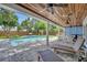 Covered patio area overlooking a pool and landscaped backyard at 624 Richmond Street, Orlando, FL 32806
