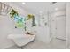 Stylish bathroom with a soaking tub, glass shower, and hanging plants at 624 Richmond Street, Orlando, FL 32806