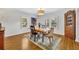Sunlit dining room boasts hardwood floors, plantation shutters, and charming corner cabinet at 624 Richmond Street, Orlando, FL 32806