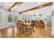 Open floor plan of dining room and kitchen featuring hardwood floors and French doors to the pool area at 624 Richmond Street, Orlando, FL 32806