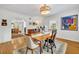Bright dining room with hardwood floors and stylish chandelier, adjacent to the open kitchen at 624 Richmond Street, Orlando, FL 32806